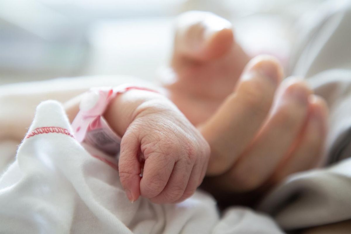 new born baby hand hold mum index finger