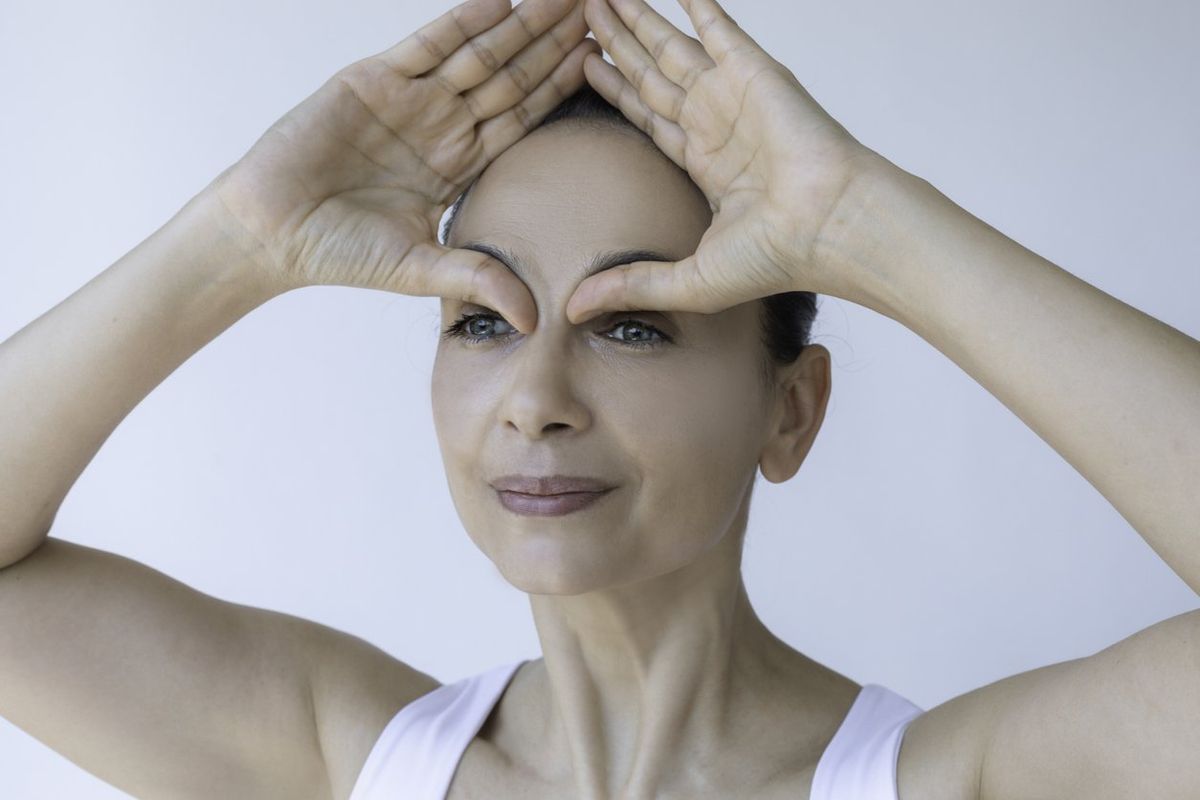 woman doing face yoga