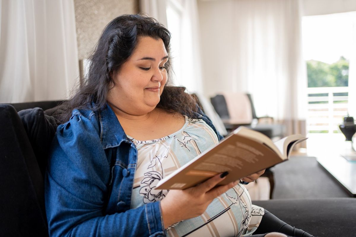 Woman reading book at home